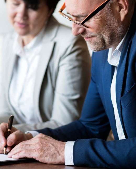 Married elderly couple signing marriage certificate